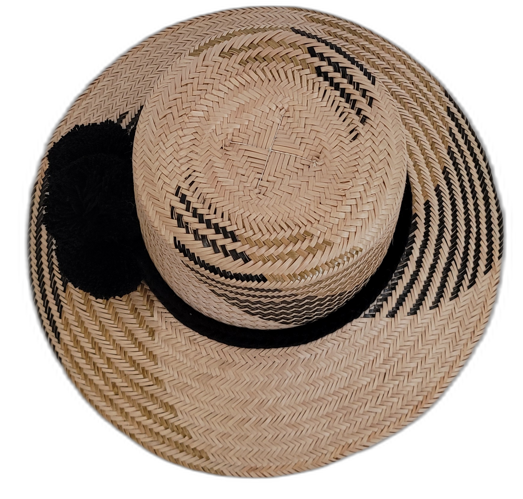 Artisan-crafted Wayuu hat in natural straw with bold black pompoms.

