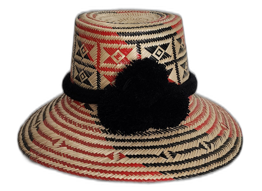 Handmade Wayuu straw hat with red and black geometric weave and black pompoms.Arya handmade Wayuu hat with red and black diamond pattern and black pompoms