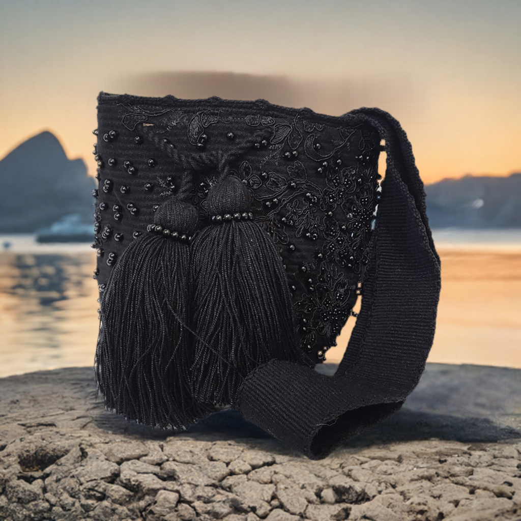 Handmade all-black Wayuu crochet bag with large tassels and beaded accents.