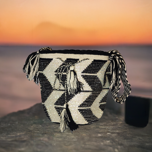 Handmade Wayuu crochet bag in black and white with crystal embellishments.