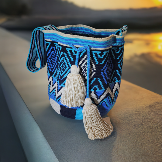 Handmade Wayuu crochet boho bag with blue, black, and cream geometric patterns.