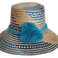 Handmade Wayuu straw hat with navy and sky blue weave and turquoise pompoms
