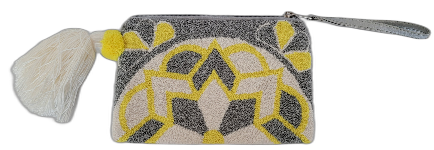 Bohemian crochet clutch with floral punch needle design and bright pom tassel

