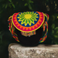 Colorful bohemian crochet Wayuu bag with sunburst design and vibrant tassels