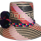 Bohemian chick straw hat featuring bold dark pompoms and tribal design