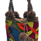 Boho-chick Wayuu crochet handbag featuring bold bird and flower embroidery
