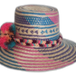 Boho straw hat featuring bright artisan patterns and large pompoms