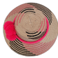 Bohemian straw hat in pink and black, handmade with Iraca palm, decorated with signature Wayuu pompoms, elegant and stylish.