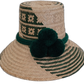 Handmade Wayuu bohemian straw hat with striking green pompoms and beige patterns.

