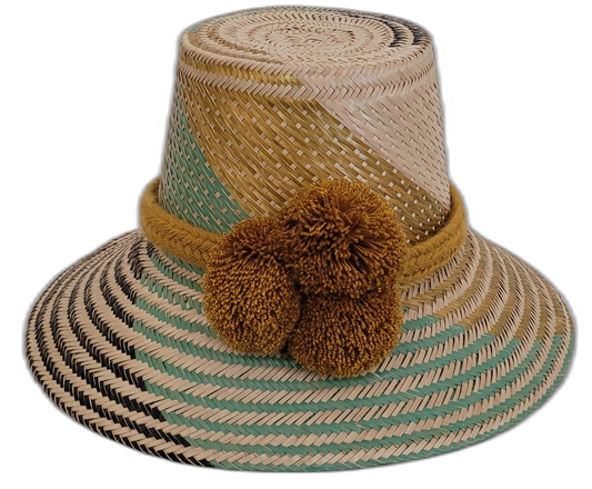 Handmade Wayuu bohemian straw hat with golden brown pompoms and mint-gold beige woven patterns.

