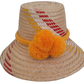Handmade Wayuu bohemian straw hat with bright orange pompoms and yellow-red woven patterns.


