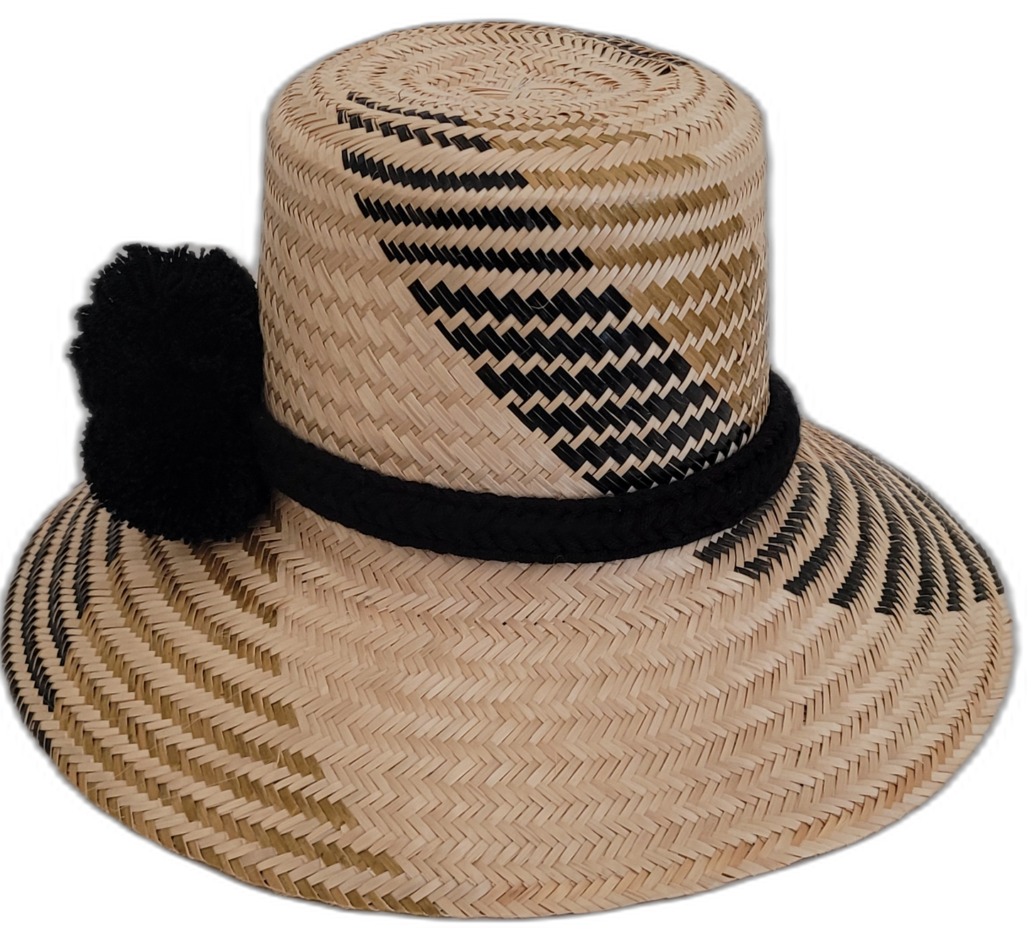 Boho-chic Wayuu straw hat featuring black pompoms and intricate design.


