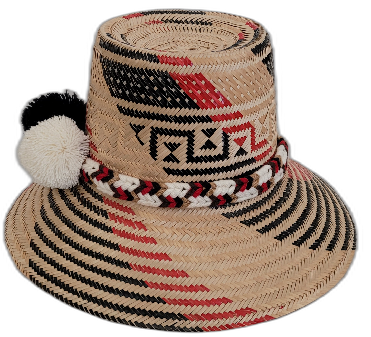 Artisan Wayuu hat with striking black-and-white pompoms and detailed red patterns.

