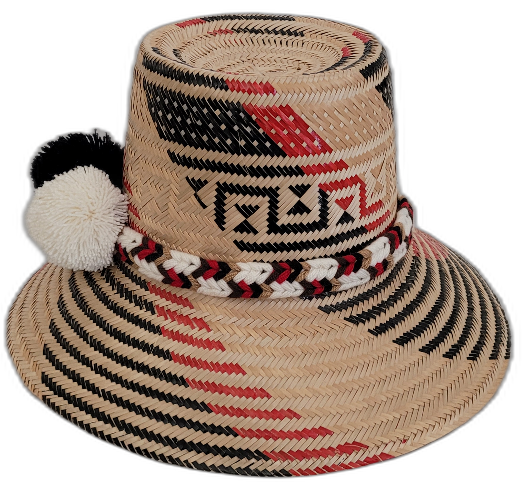 Artisan Wayuu hat with striking black-and-white pompoms and detailed red patterns.

