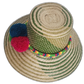Bohemian straw hat featuring forest-green design and handmade pompoms in bright complementary tones.