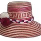 Boho straw hat featuring bold pompoms and intricate Wayuu patterns