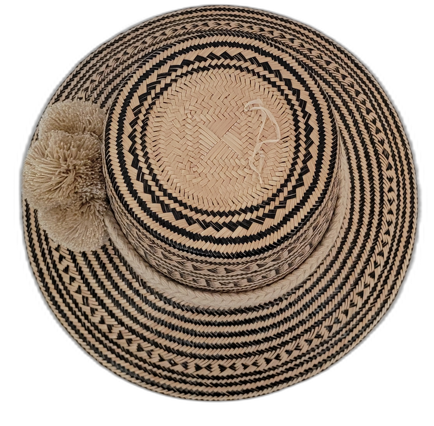 Colorful Wayuu hat handwoven from Iraca palm, showcasing traditional black and tan designs

