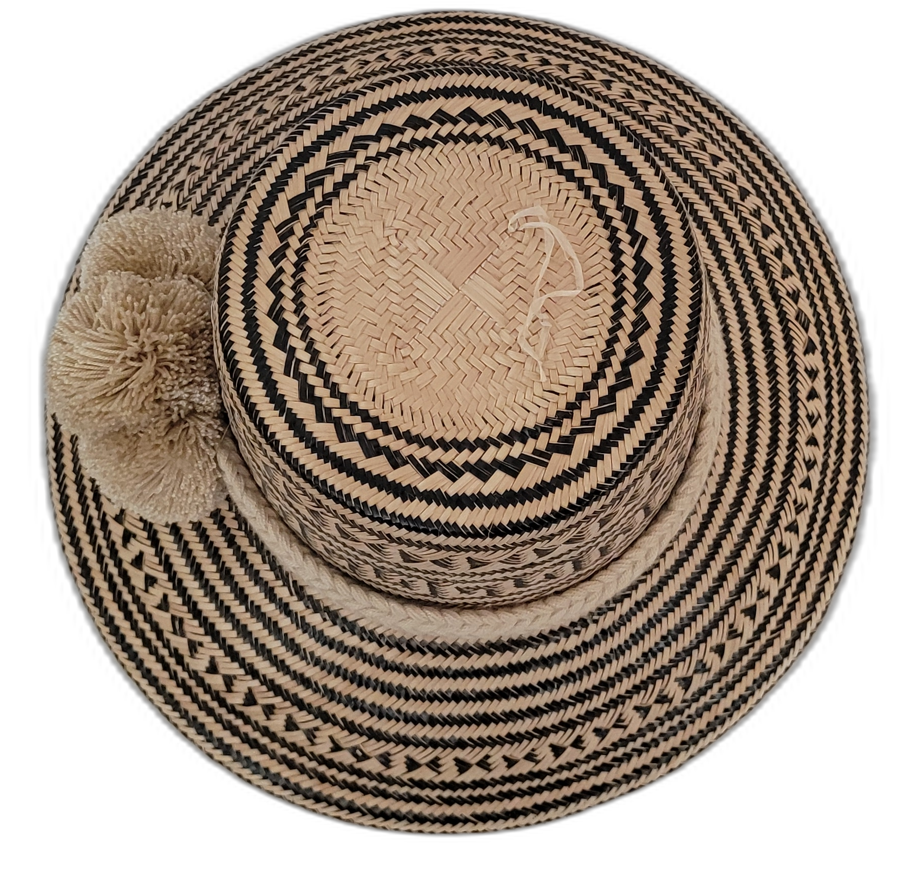 Colorful Wayuu hat handwoven from Iraca palm, showcasing traditional black and tan designs

