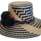 Artisan Boho hat with geometric blue-black weave and bold pompom accent.Elegant bohemian straw hat with cultural patterns and soft woven band

