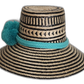 Artisan Wayuu hat in black and tan with turquoise wool band and pompoms.Natural straw boho hat with horizontal black stripes and bright turquoise accents

