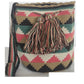 Bohemian crochet Wayuu bag featuring soft earth tones, geometric patterns, and artisan tassel detail — perfect for boho style lovers.