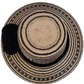 Boho chic black Wayuu straw hat, featuring deep black woven patterns and pompoms.

