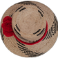 Black and natural Wayuu handmade straw hat with eye-catching red pompoms.


