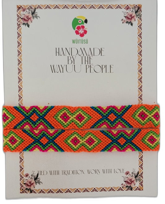 Bohemian handmade bracelet with striking Boho chick colors — orange, fuchsia, green, and blue — woven in traditional Wayuu tribal patterns for a radiant, ethical style.