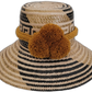 Handmade bohemian straw hat with black pattern and mustard pompoms, crafted by Wayuu artisans.

