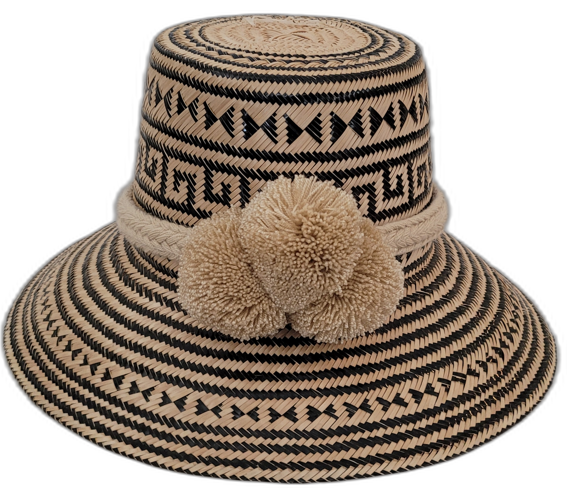 Handmade Wayuu straw hat featuring bold black and natural palm patterns with large pompoms

