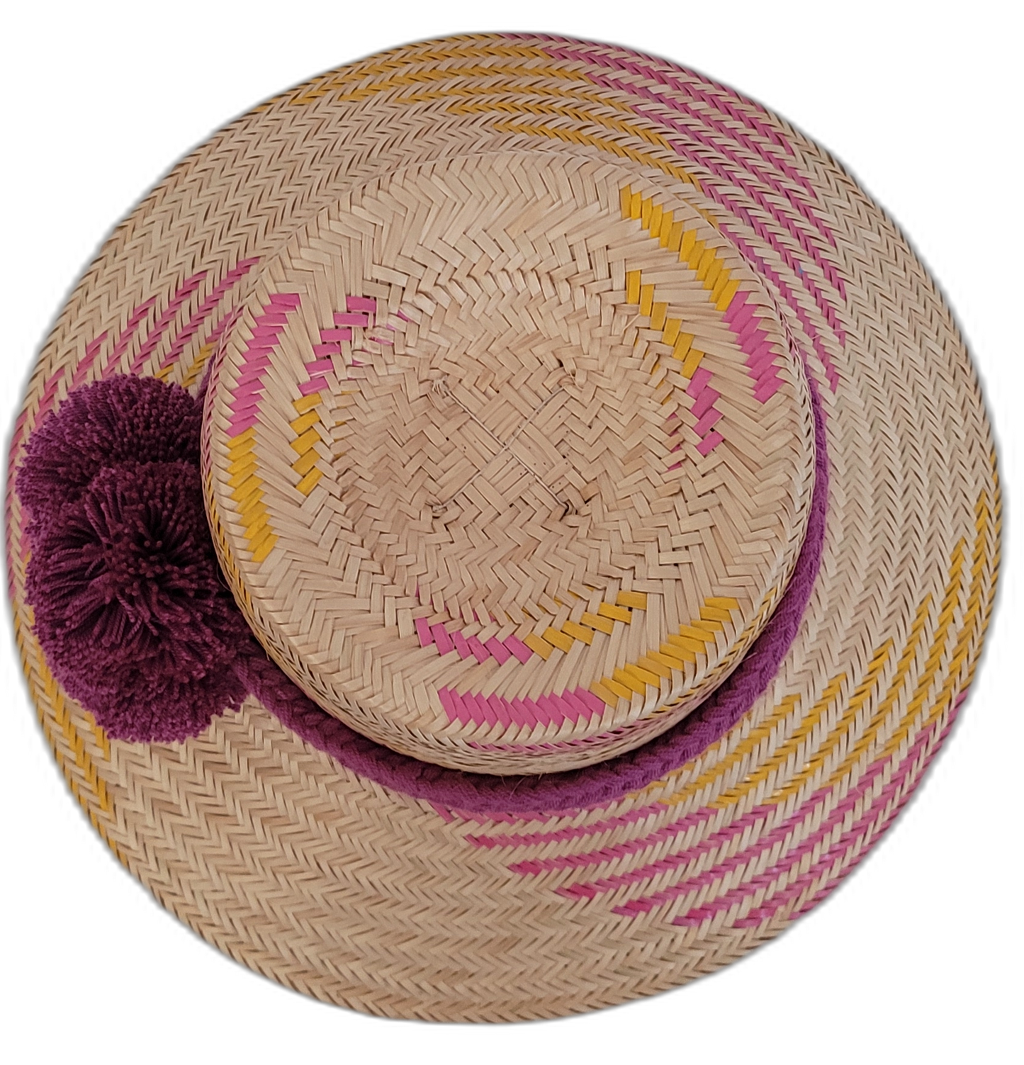 Boho Chic hat, Wayuu artisan-made, straw hat with vibrant pink, yellow, and purple designs, adorned with pompoms.