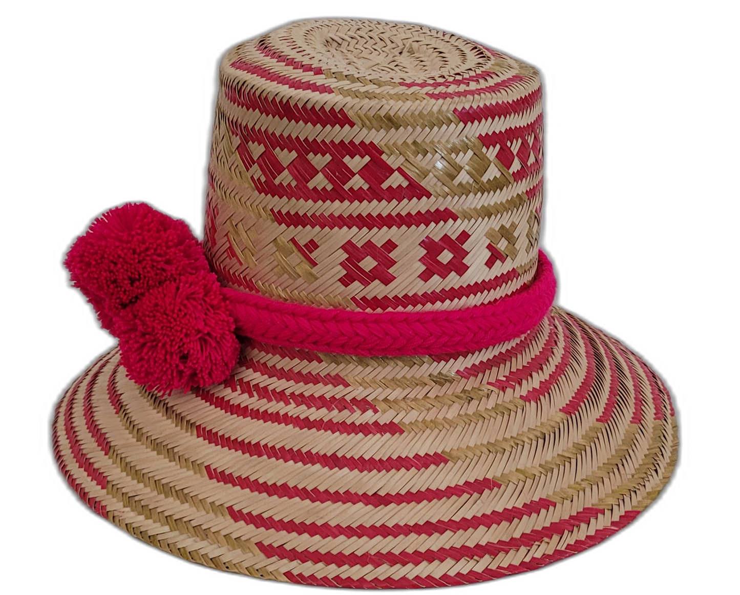 Boho straw hat handwoven by Wayuu artisans with eye-catching red pompoms.

