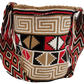 Large boho chick crochet bag in black, red, tan tones, artisan crossbody strap, striking geometric design, and playful multicolor tassels.