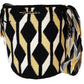 Large boho chick crochet bag in black, tan, and white, artisan crossbody strap, bold geometric wave pattern, and striking tassel accents.