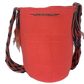 Large boho chick crochet bag with coral base, artisan crossbody strap in red, blue, black, white, and dynamic oversized tassels.