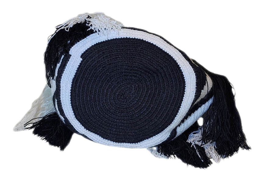 Bottom view Large boho chick crochet handbag in black and white, artisan zigzag pattern, sturdy braided handles, and bold black and white tassel accents.