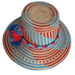 Boho Chick hat featuring woven red-blue pattern and bold pompoms