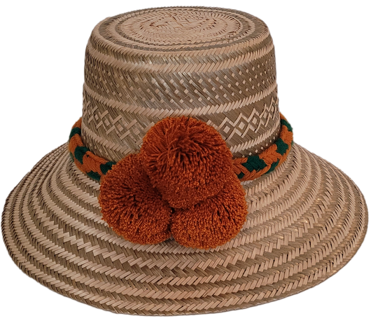 Handmade straw Wayuu hat with rust-orange pompoms and colorful woven band