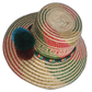 Boho chick straw hat crafted by Wayuu artisans, featuring vibrant red and green chevron accents and dark pompoms.