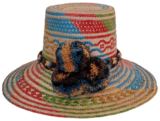 Handmade Wayuu straw hat with colorful weave and earth-toned pompoms