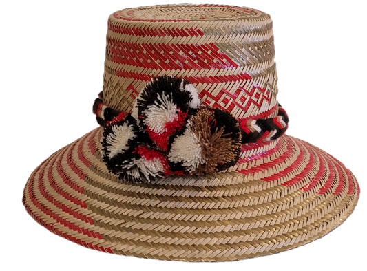 Boho chick straw hat with red and black pompoms, handmade by Wayuu artisans