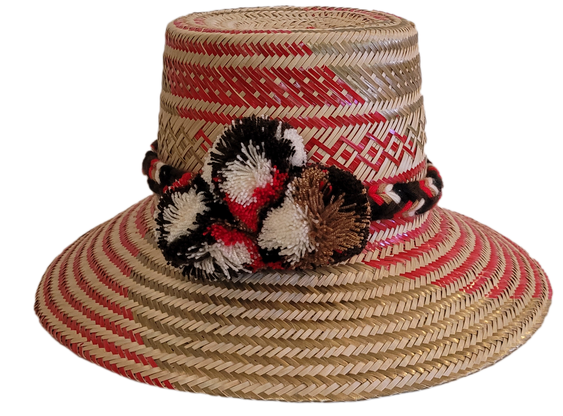 Boho chick straw hat with red and black pompoms, handmade by Wayuu artisans
