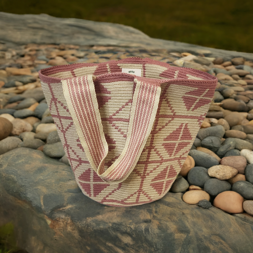 Boho-chick Wayuu crochet tote in pink and beige with geometric handmade patterns.