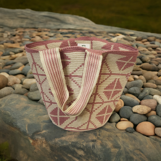 Boho-chick Wayuu crochet tote in pink and beige with geometric handmade patterns.