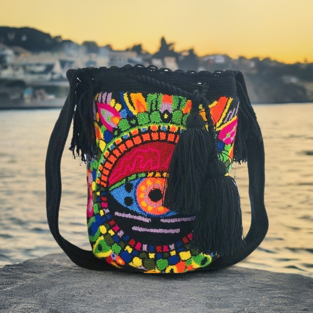 Bottom view Bohemian handmade Wayuu bag featuring bright abstract eye pattern