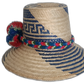 Boho chick straw hat featuring traditional blue weave and bold pompoms