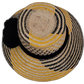 Black and yellow Wayuu hat with cultural pompoms and bold contrast