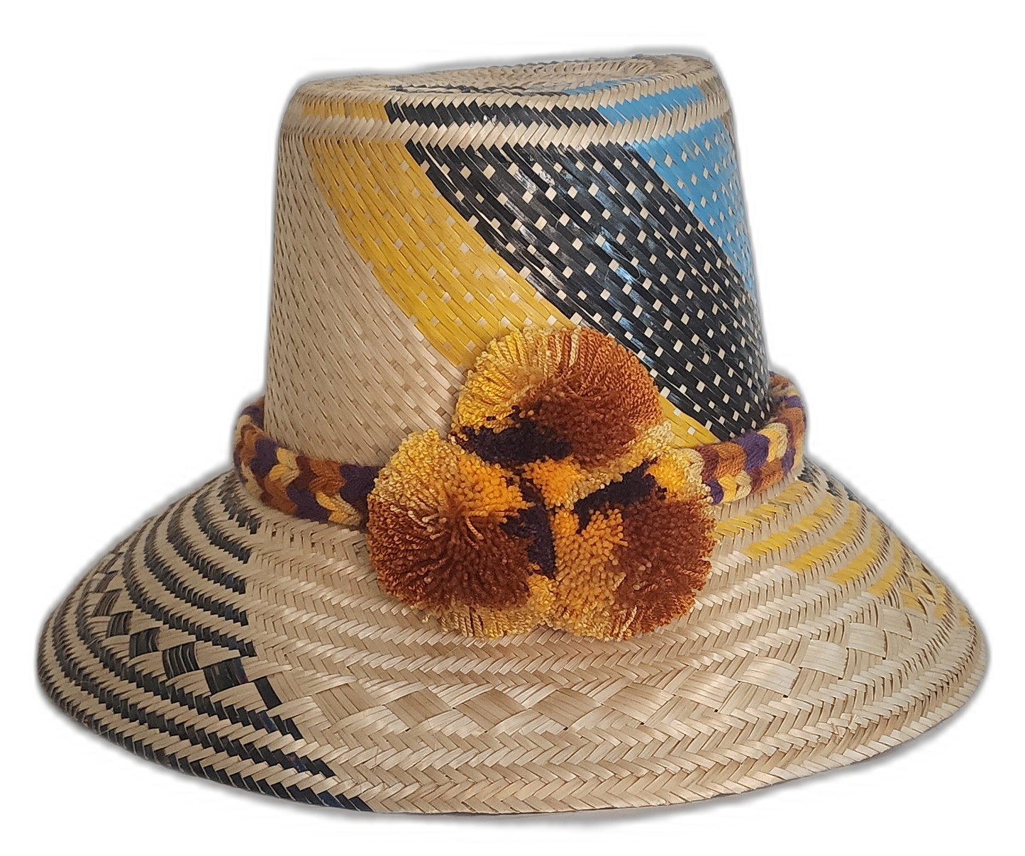 A colorful boho straw hat handmade by Wayuu artisans, featuring yellow, black, and blue patterns woven from Iraca palm with a pompom detail.