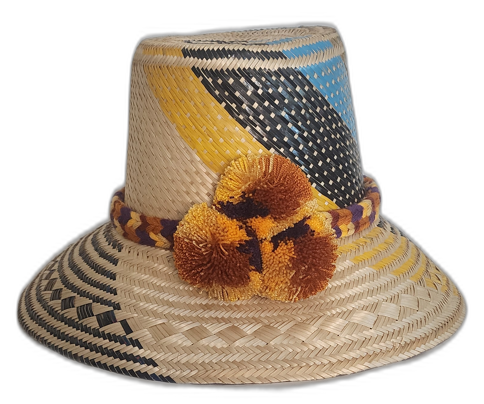 A colorful boho straw hat handmade by Wayuu artisans, featuring yellow, black, and blue patterns woven from Iraca palm with a pompom detail.