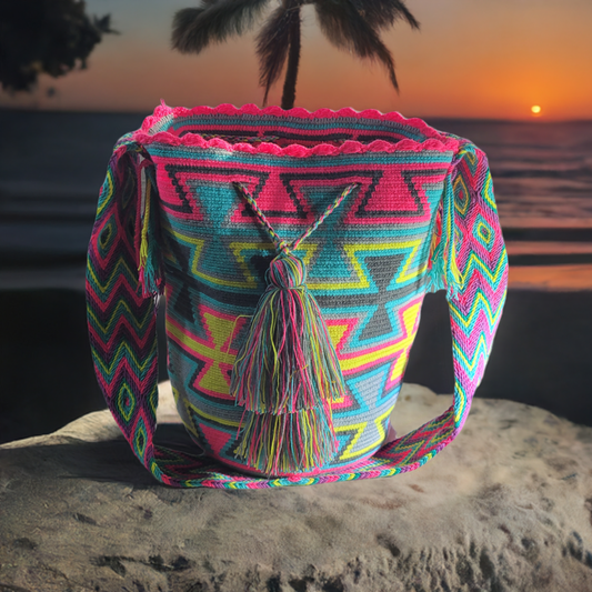 Colorful handmade Wayuu crochet bag with bold neon geometric patterns and boho-chic tassels.